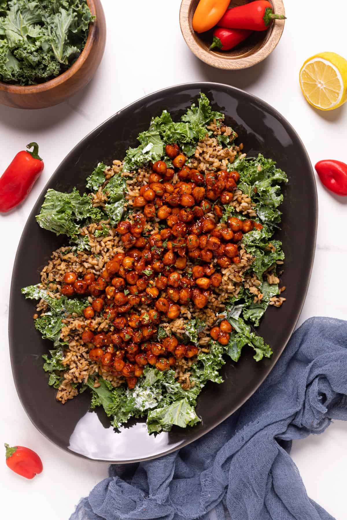 Healthy Loaded Kale Salad with Spicy Chickpeas on a black serving platter