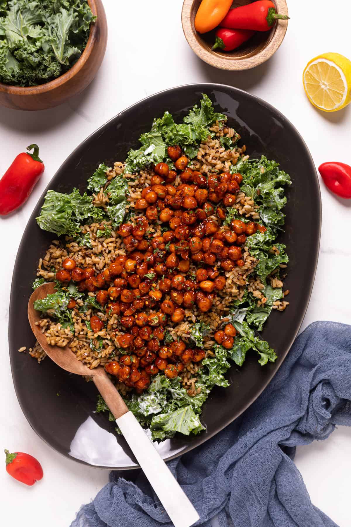 Healthy Loaded Kale Salad with Spicy Chickpeas on an oblong, black plate.