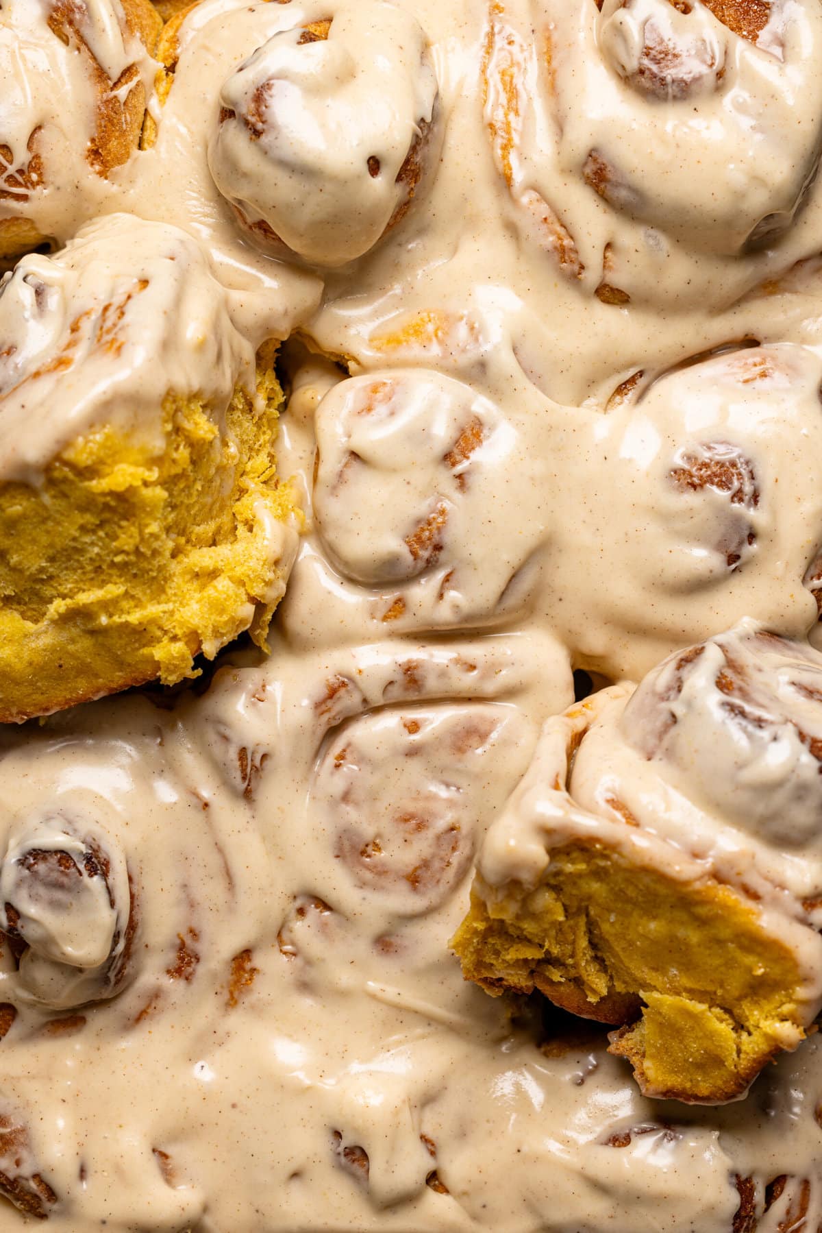 Up close shot of frosted cinnamon rolls.