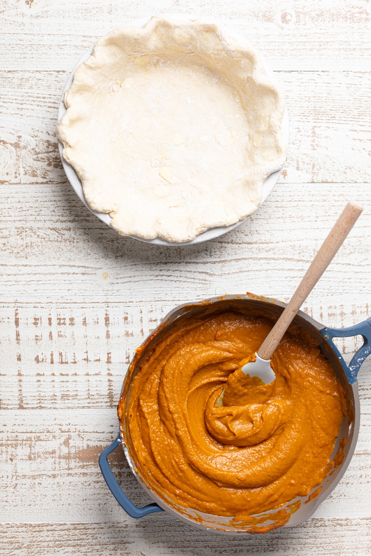 Bowl of Vegan Pumpkin Pie filled next to an empty pie crust.