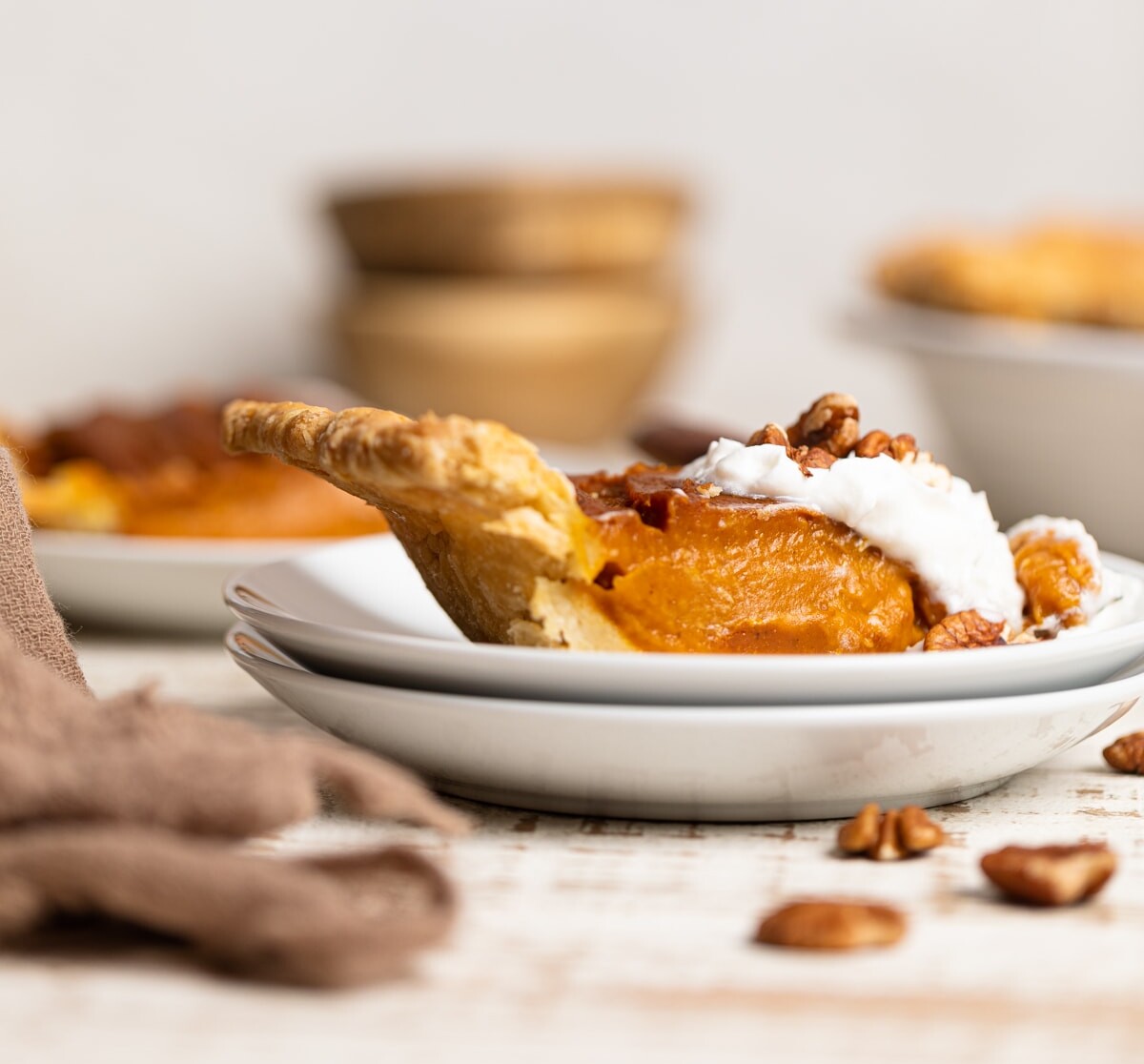 Slice of Vegan Pumpkin Pie on two small, stacked plates.