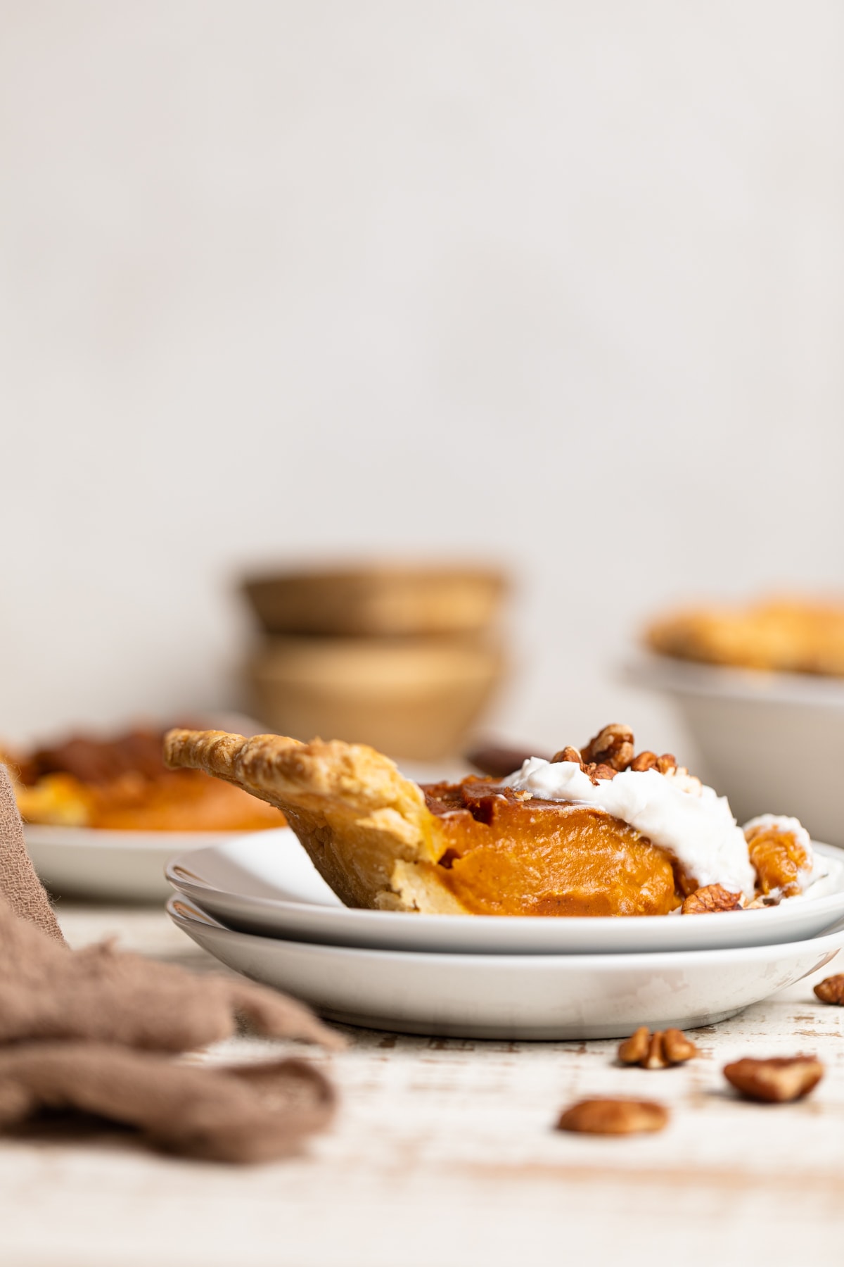 Slice of Vegan Pumpkin Pie on two small, stacked plates.