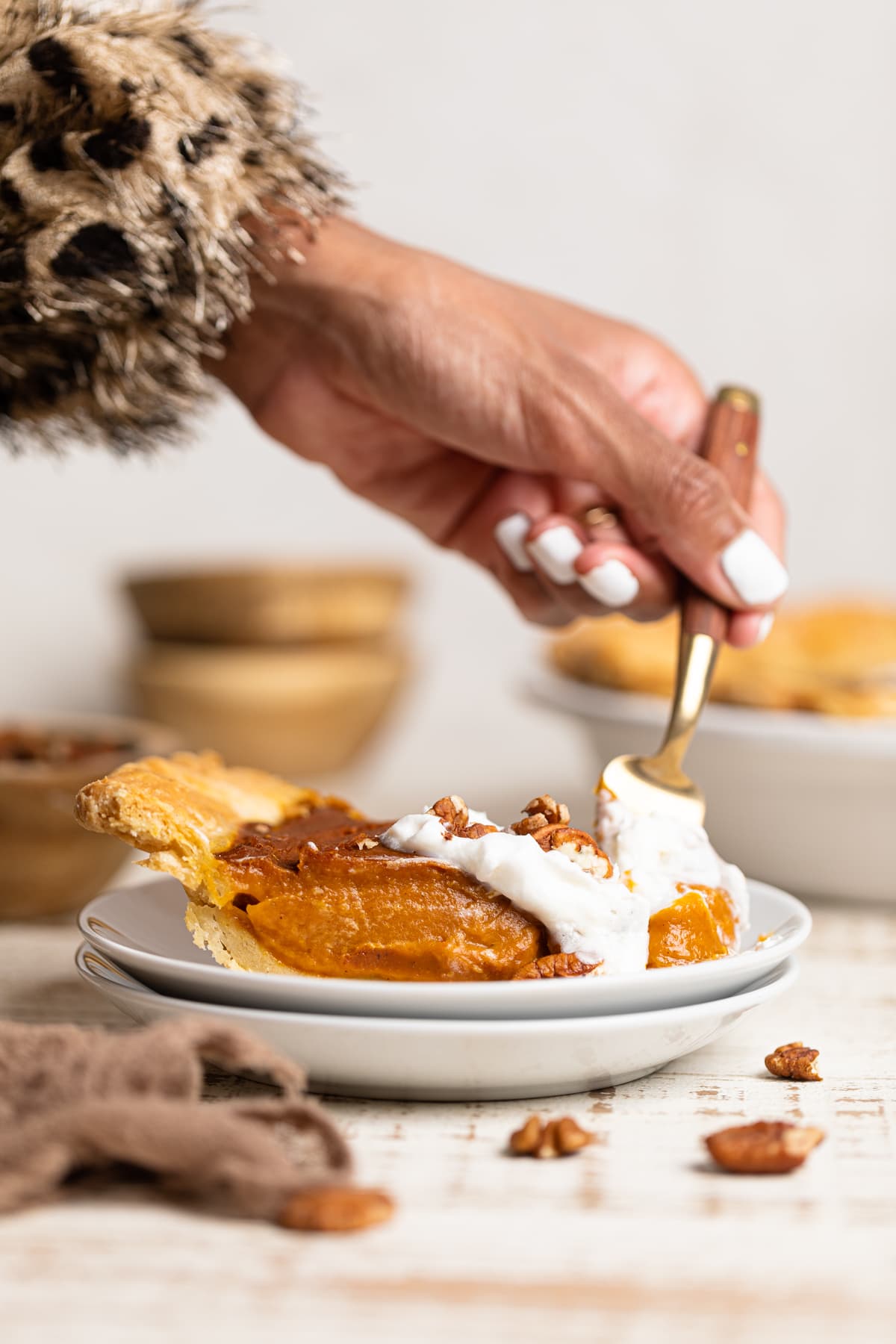 Woman using a fork to grab some Vegan Pumpkin Pie.