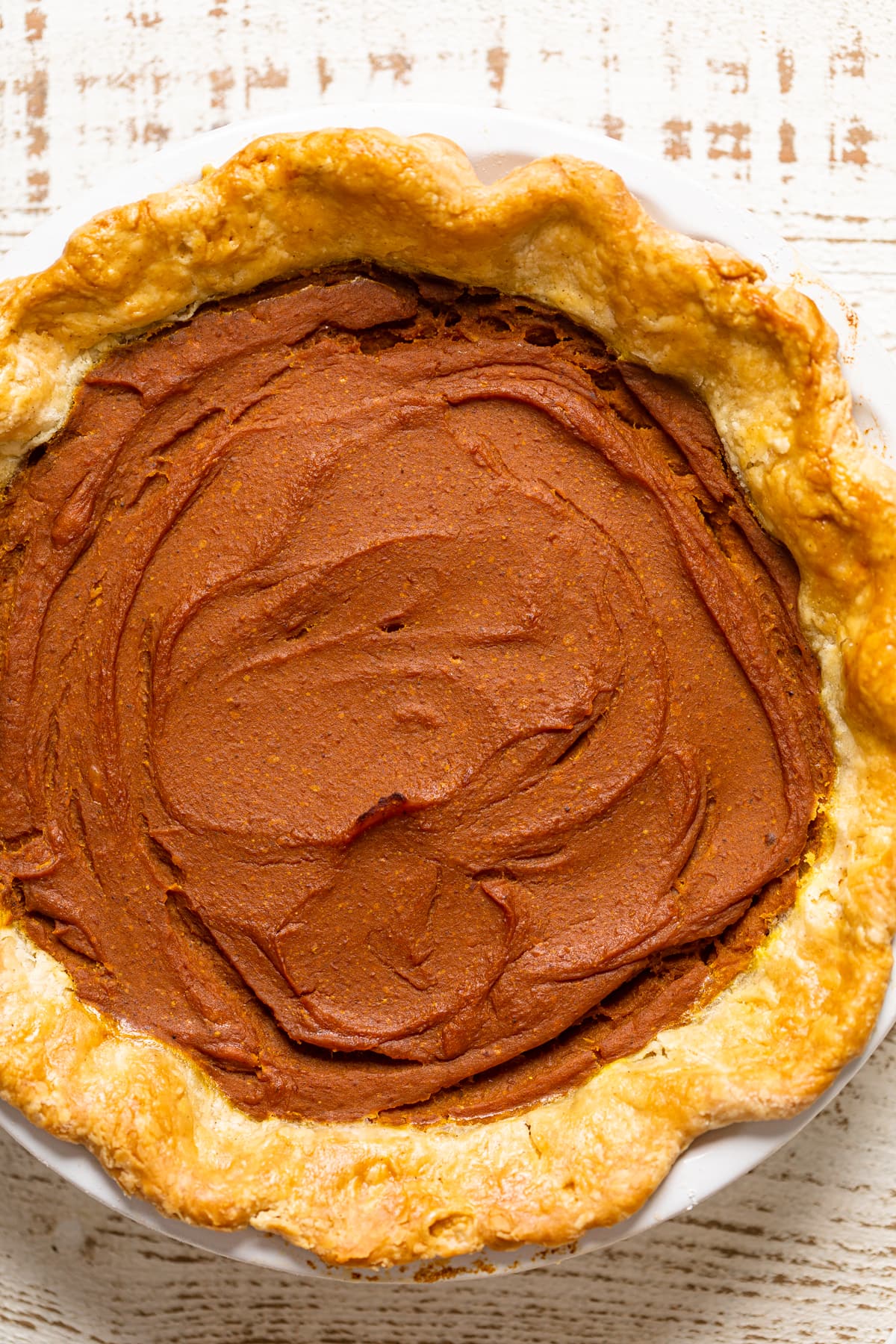 Cooked Vegan Pumpkin Pie on a countertop.