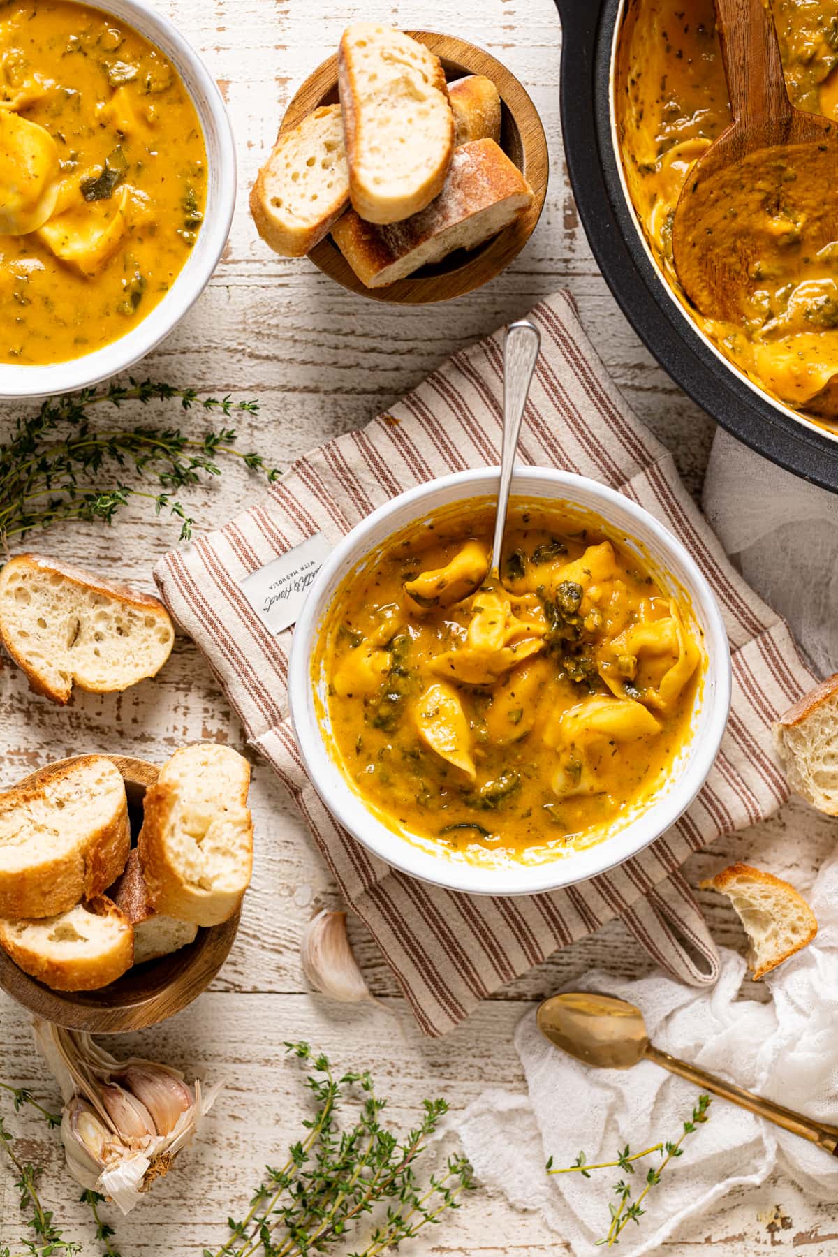 Bowl of Creamy Cajun Pumpkin Tortellini Soup on a hot pad