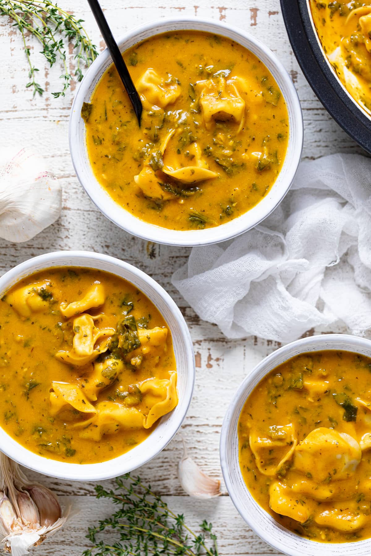 Three bowls of Creamy Cajun Pumpkin Tortellini Soup