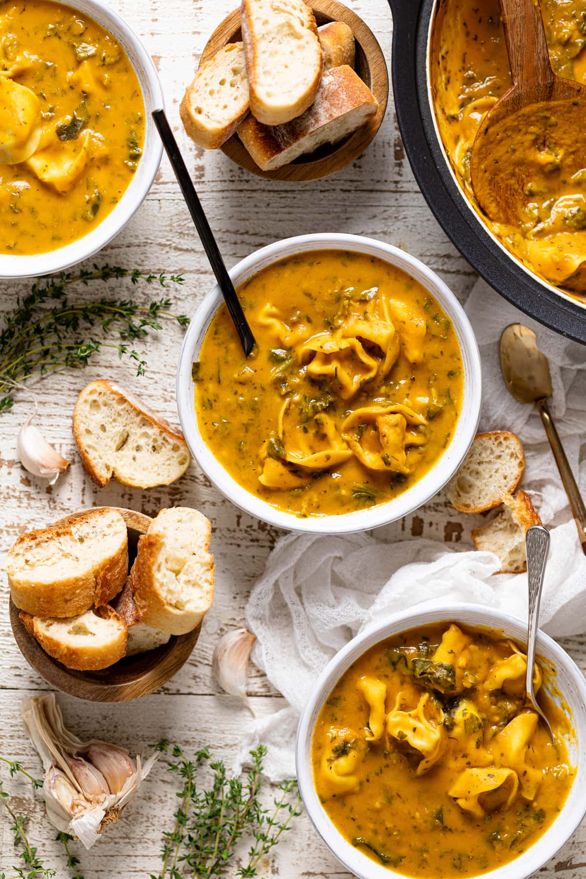 Bowls of bread and of Creamy Cajun Pumpkin Tortellini Soup