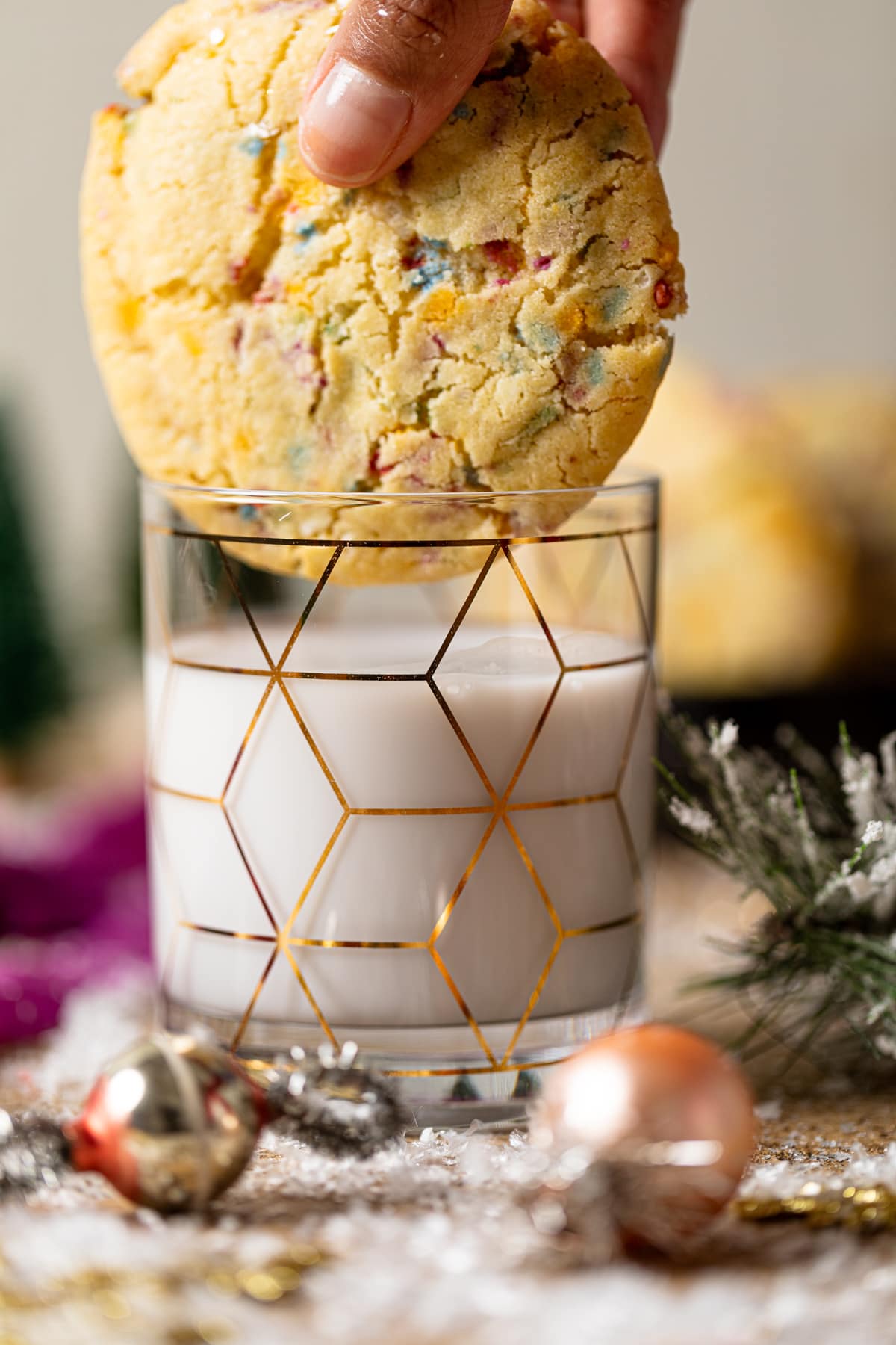 Soft Oversized Crinkled Sprinkle Sugar Cookie over a glass of milk.