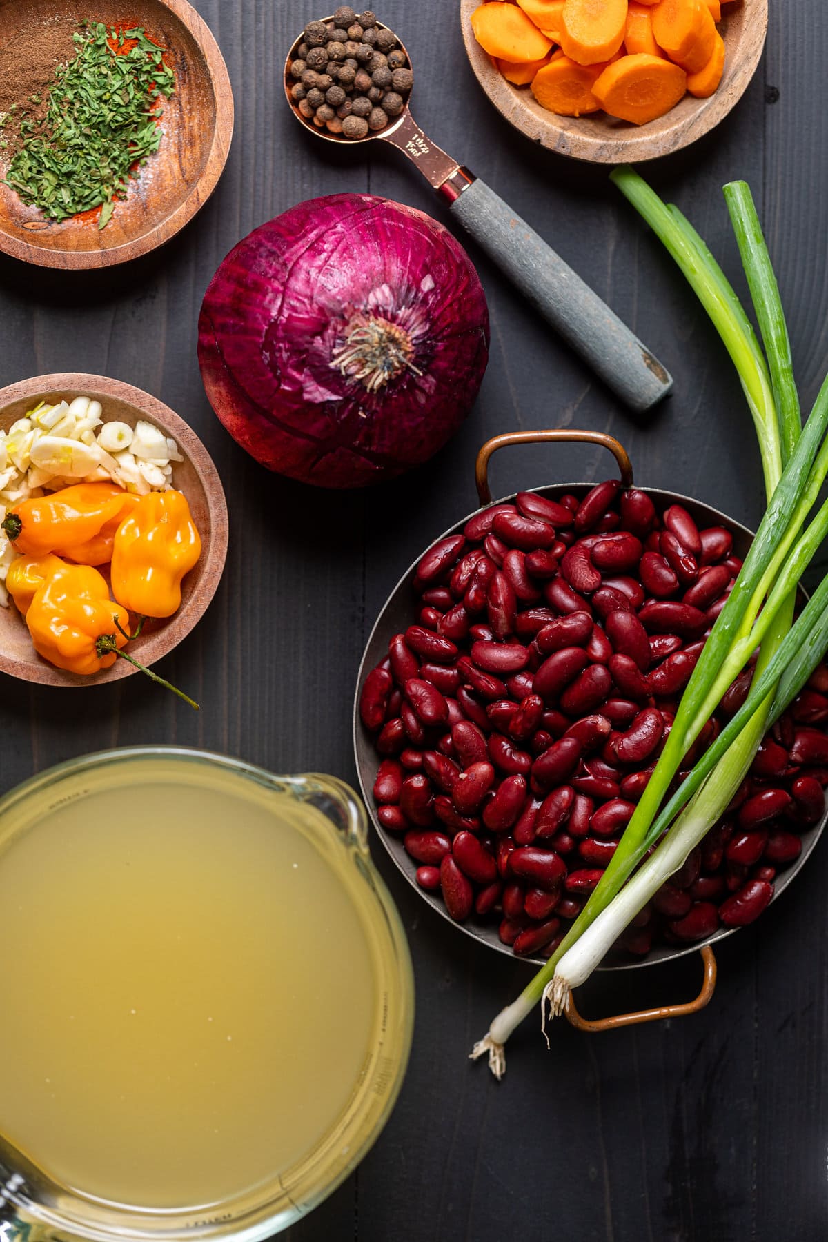 Ingredients for Vegan Jamaican Stew Peas including green onion, red onion, and garlic