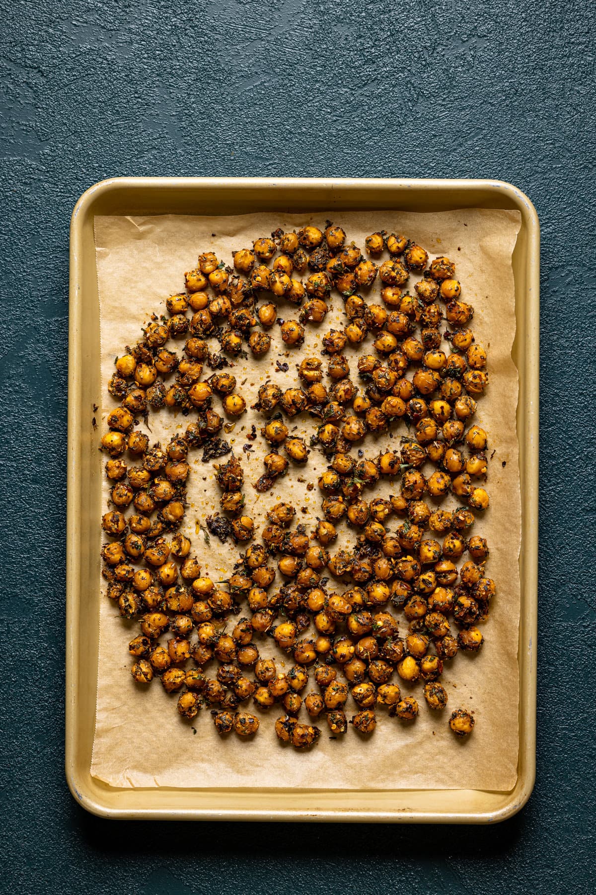 Seasoned, roasted chickpeas on a baking sheet