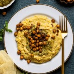 Plate of Vegan Cheese Polenta with Pesto and Chickpea with a fork