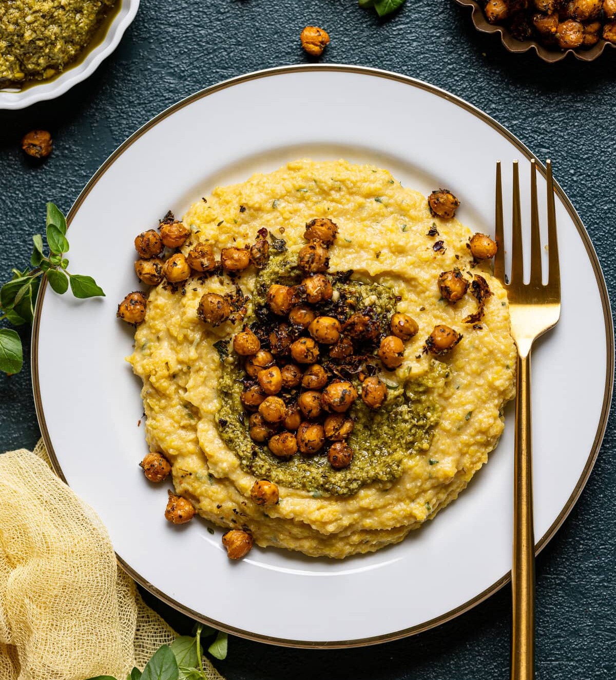 Plate of Vegan Cheese Polenta with Pesto and Chickpea with a fork