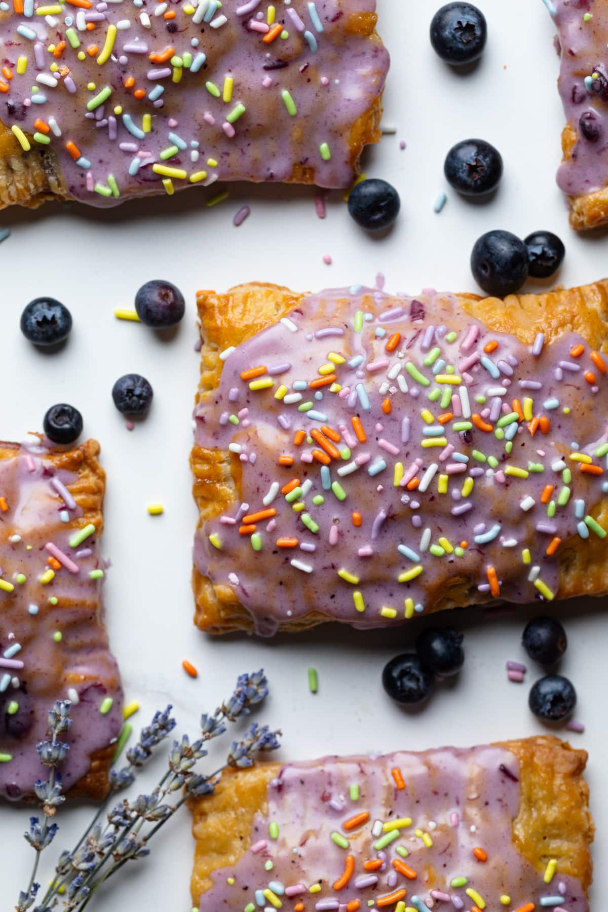 Homemade Blueberry Vegan Pop Tarts with blueberries on a white surface.