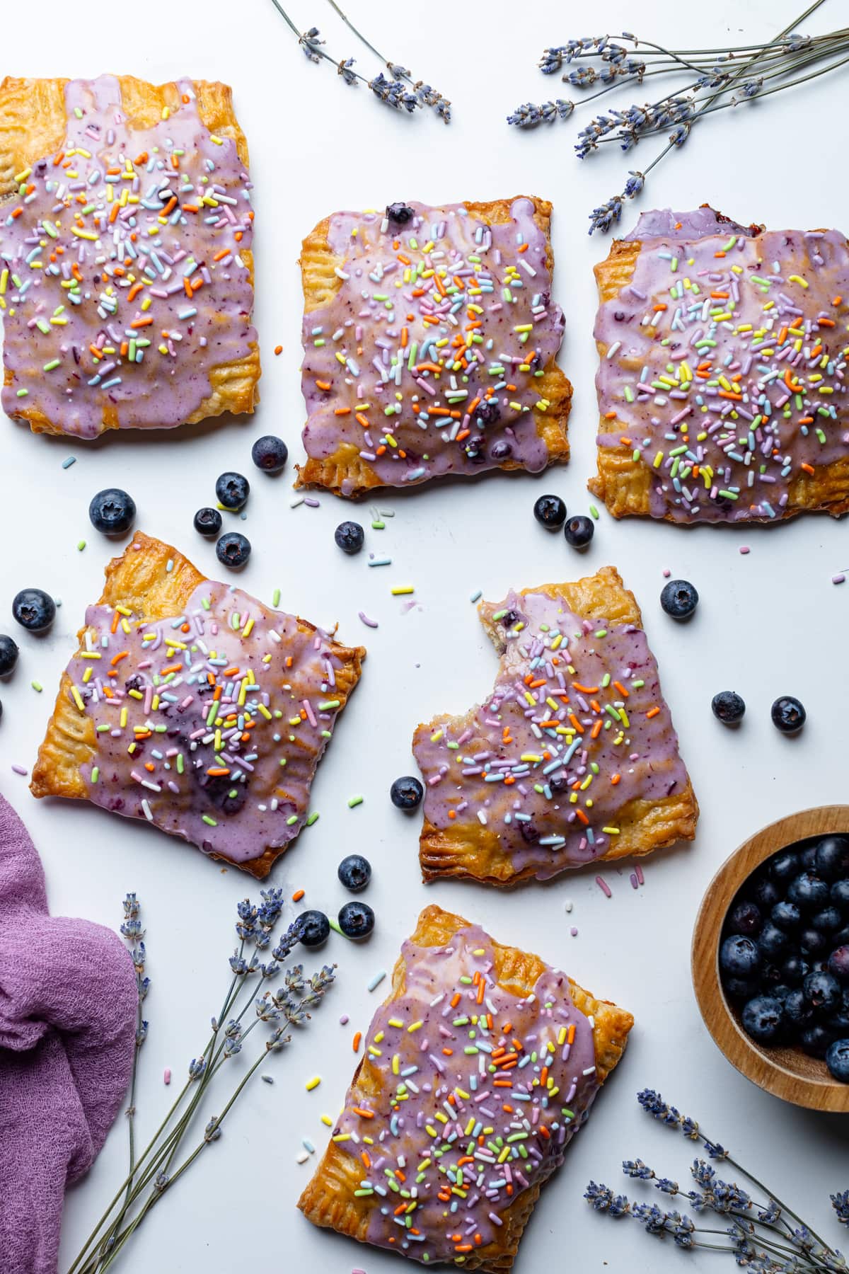 Blueberries and Homemade Blueberry Vegan Pop Tarts, one of which is missing a bite.