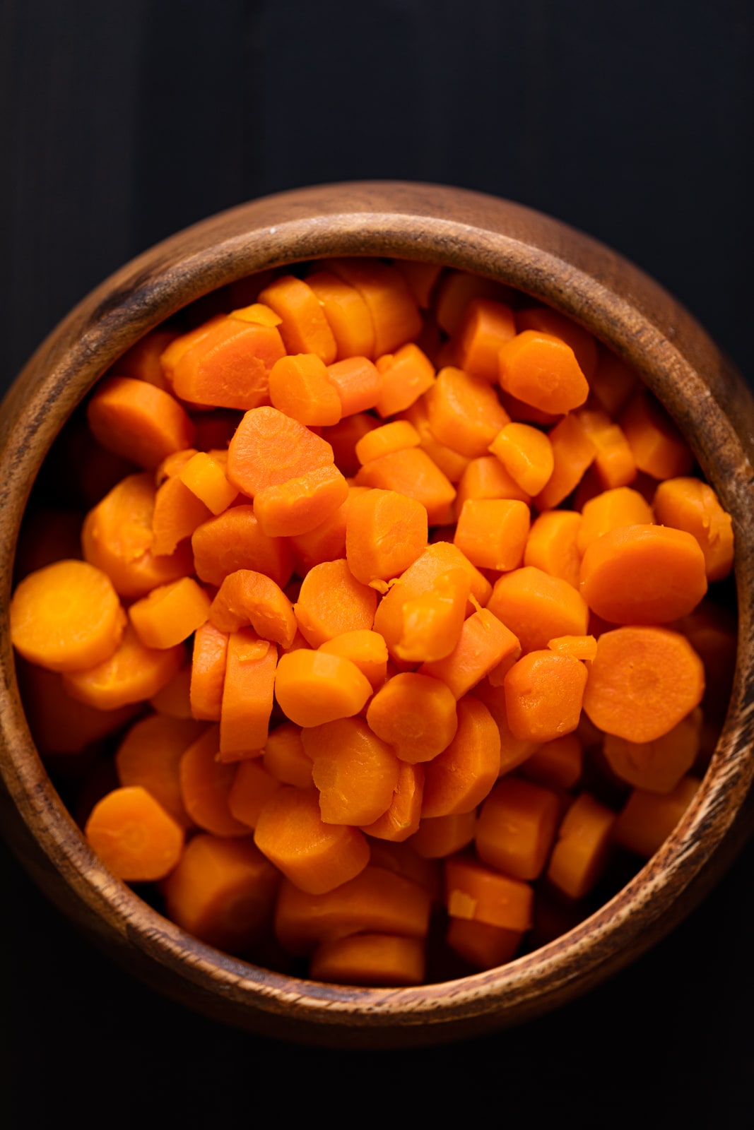 Wooden bowl of sliced carrots