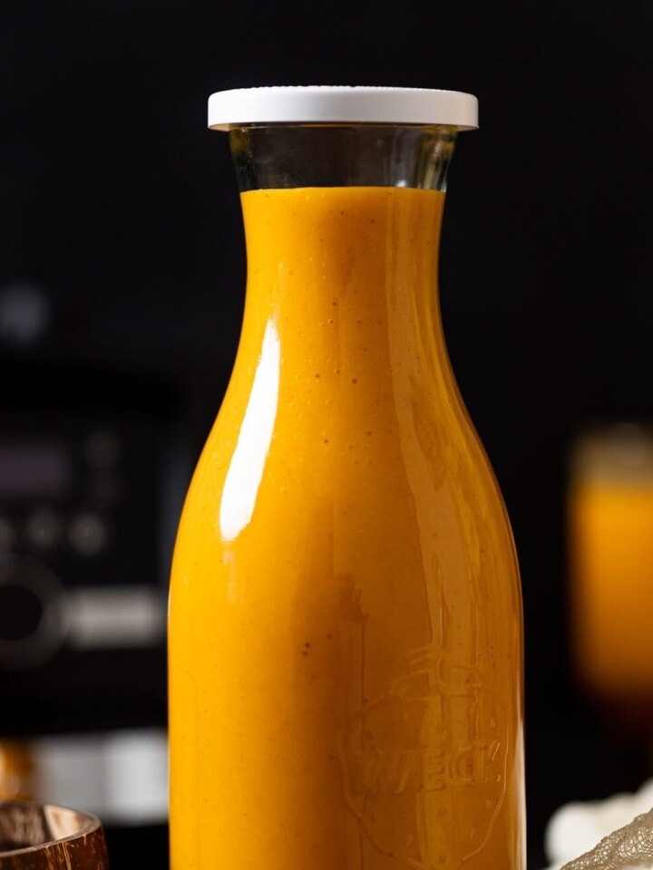 Glass carafe of Vegan Jamaican Carrot Juice