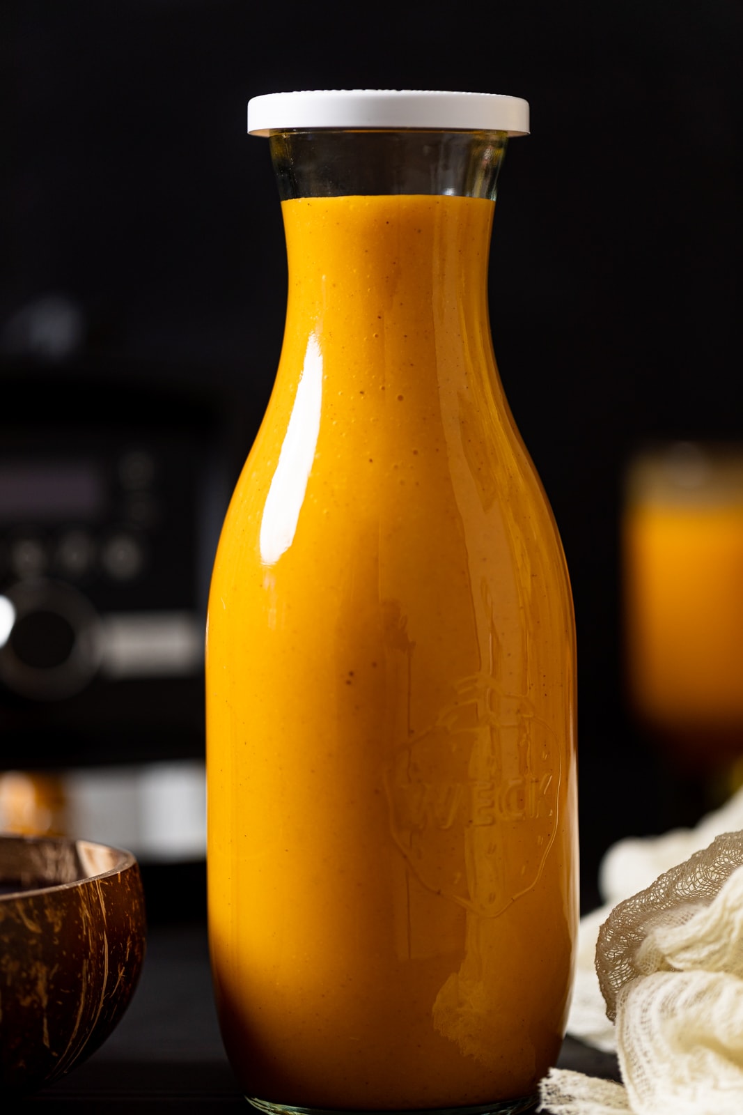 Glass carafe full of Vegan Jamaican Carrot Juice 