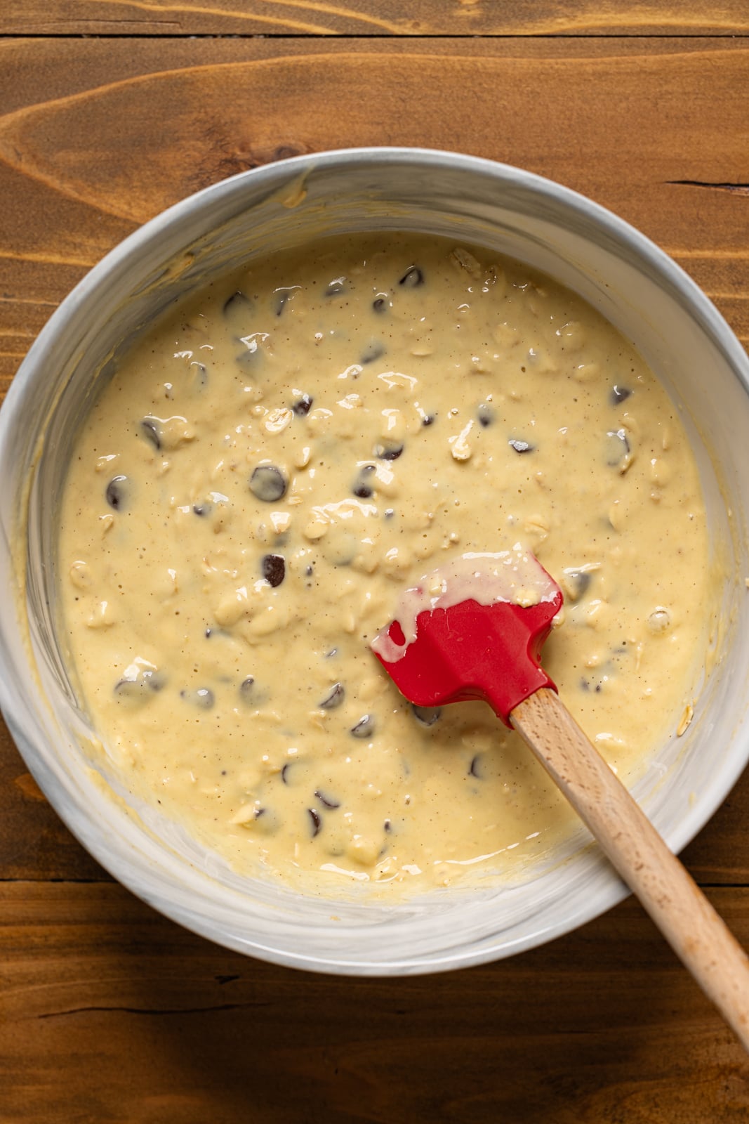 Pancake batter in a bowl with a spatula.