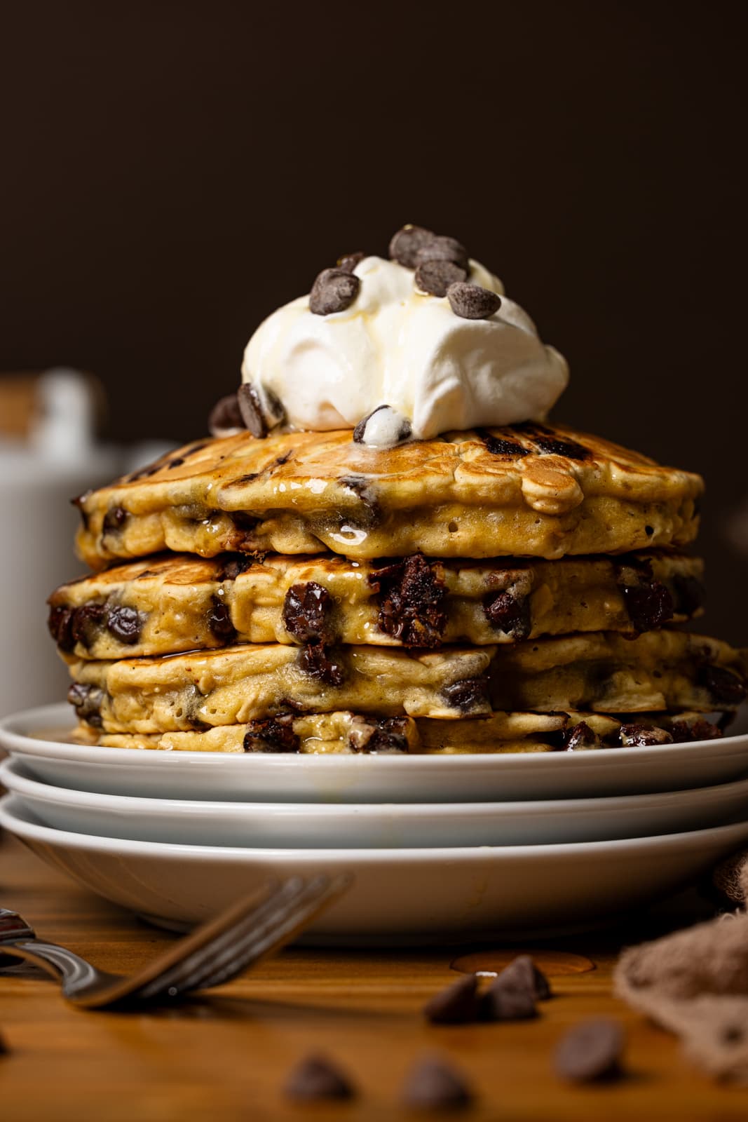 Up close shot of pancakes stacked on plates.