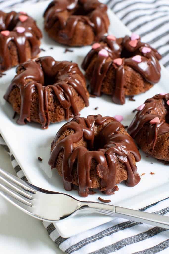 Valentine\'s Day Mini Chocolate Brownie Bundt Cakes on a plate with a fork.