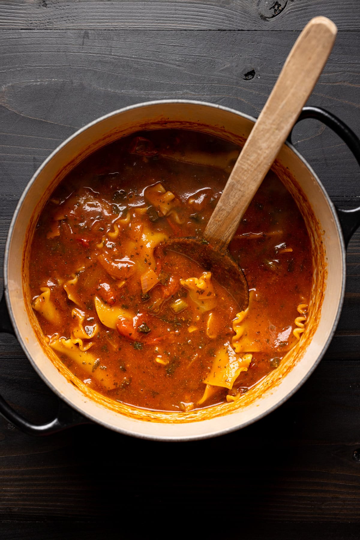 Pot of Vegan Lasagna Soup being stirred with a wooden spoon