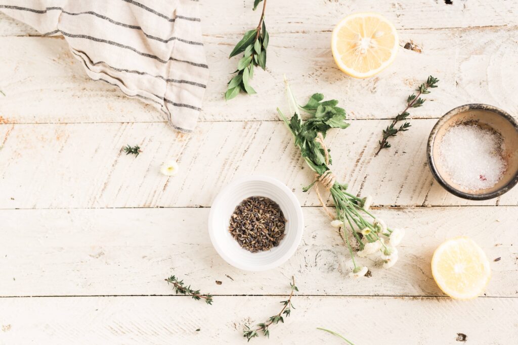 Herbs on a white, wooden table.