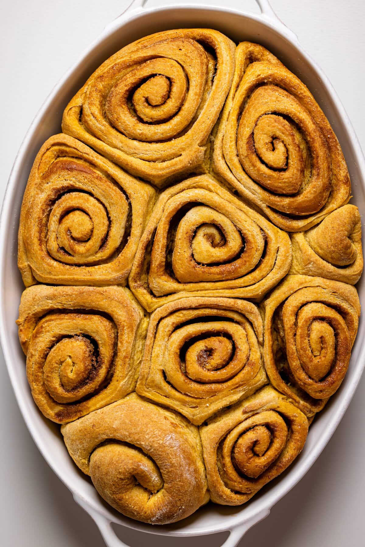 Baking pan of just-cooked Vegan Sweet Potato Cinnamon Rolls 