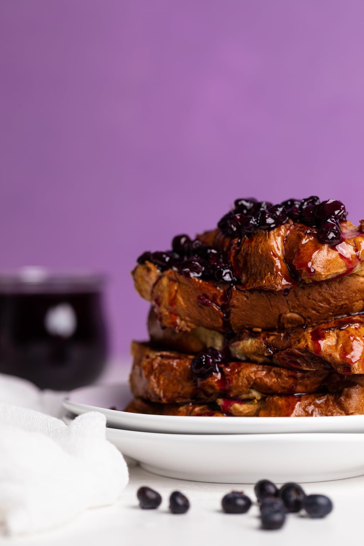 Two white plates topped with Dairy-Free Blueberry French Toast.