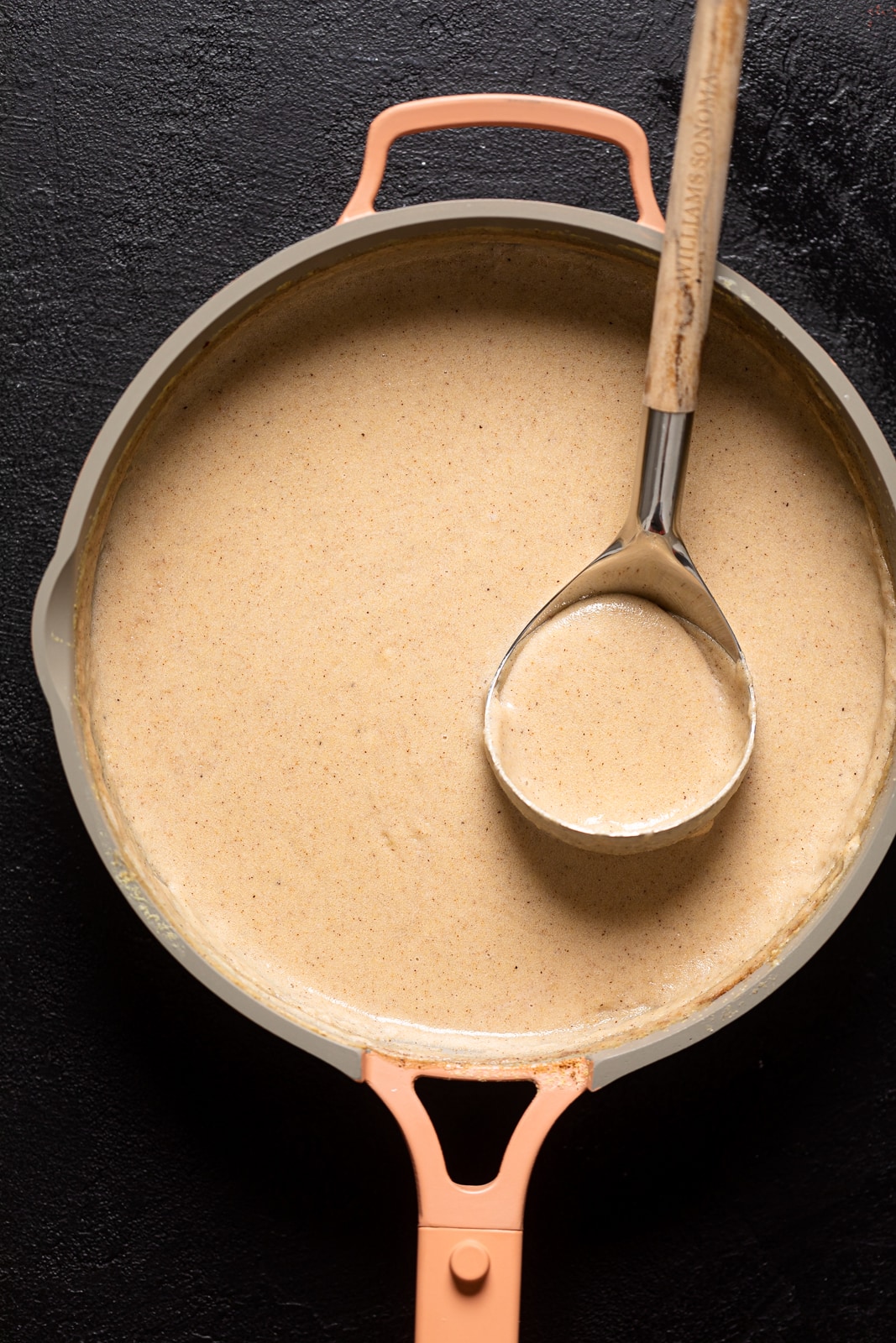 Ladle scooping Creamy Jamaican Cornmeal Porridge