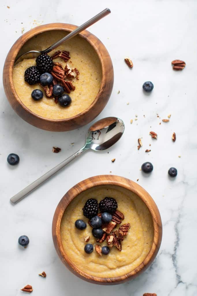 Wooden bowls of Creamy Jamaican Cornmeal Porridge.