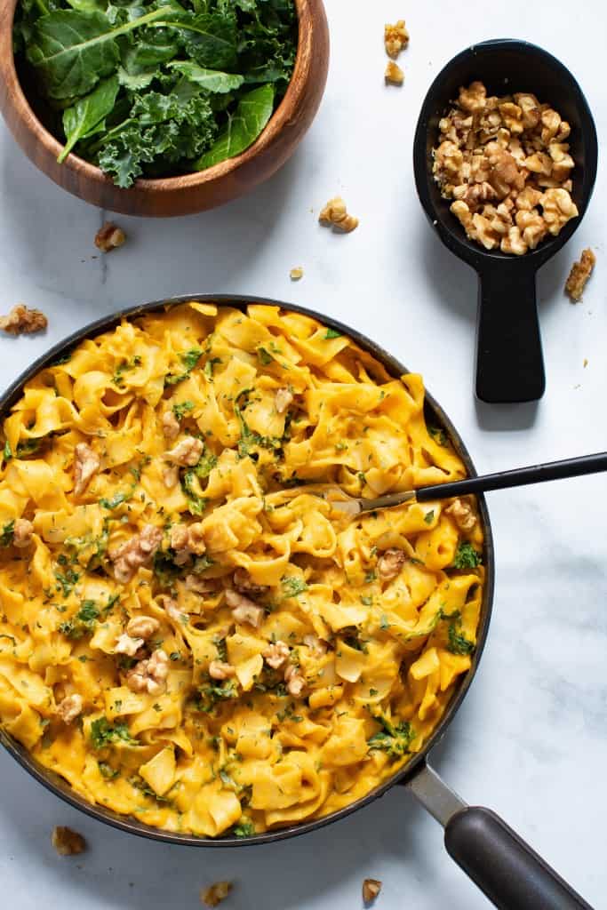 Vegan Sweet Potato Pasta with Kale and Spinach in a skillet.