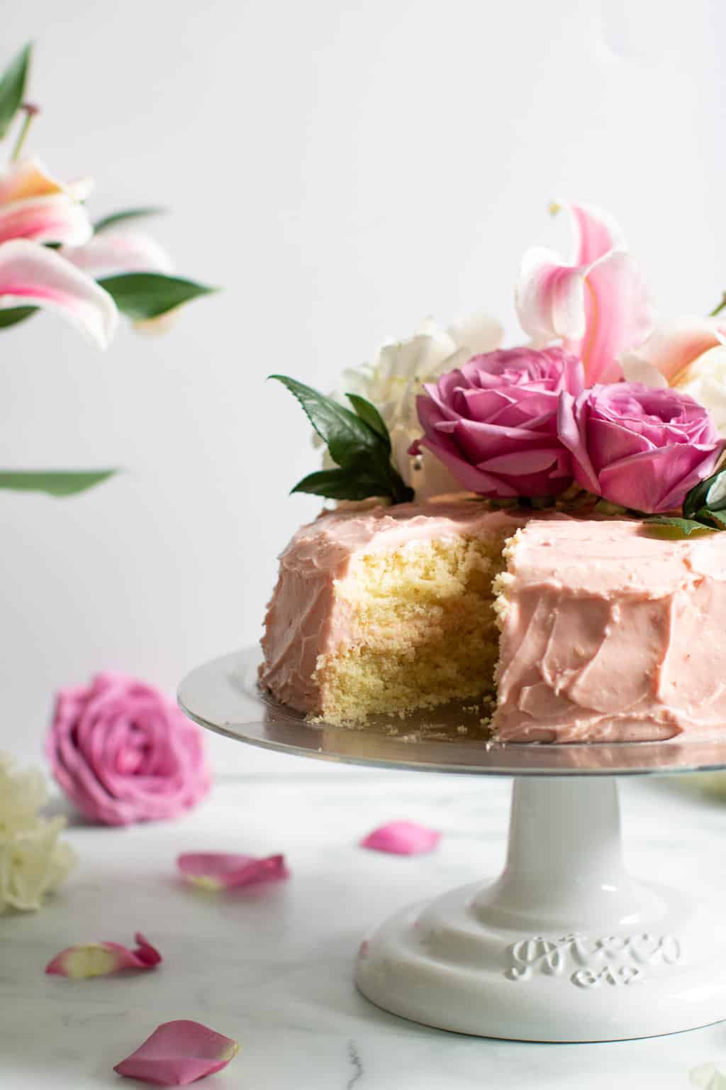 Partially-sliced Lemon and Strawberry Layer Spring Cake.