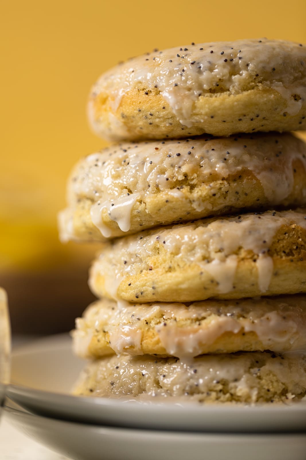 Closeup of a stack of Vegan Lemon Poppy Seed Donuts