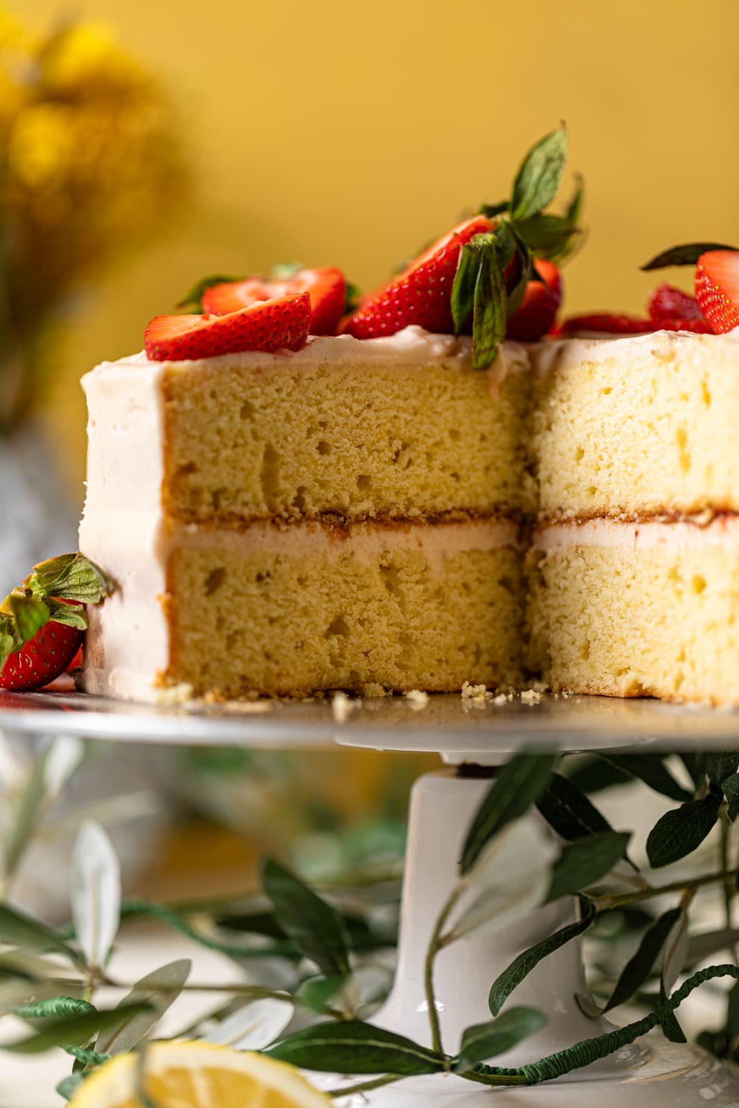Closeup of a Lemon Strawberry Layer Cake that is missing a slice