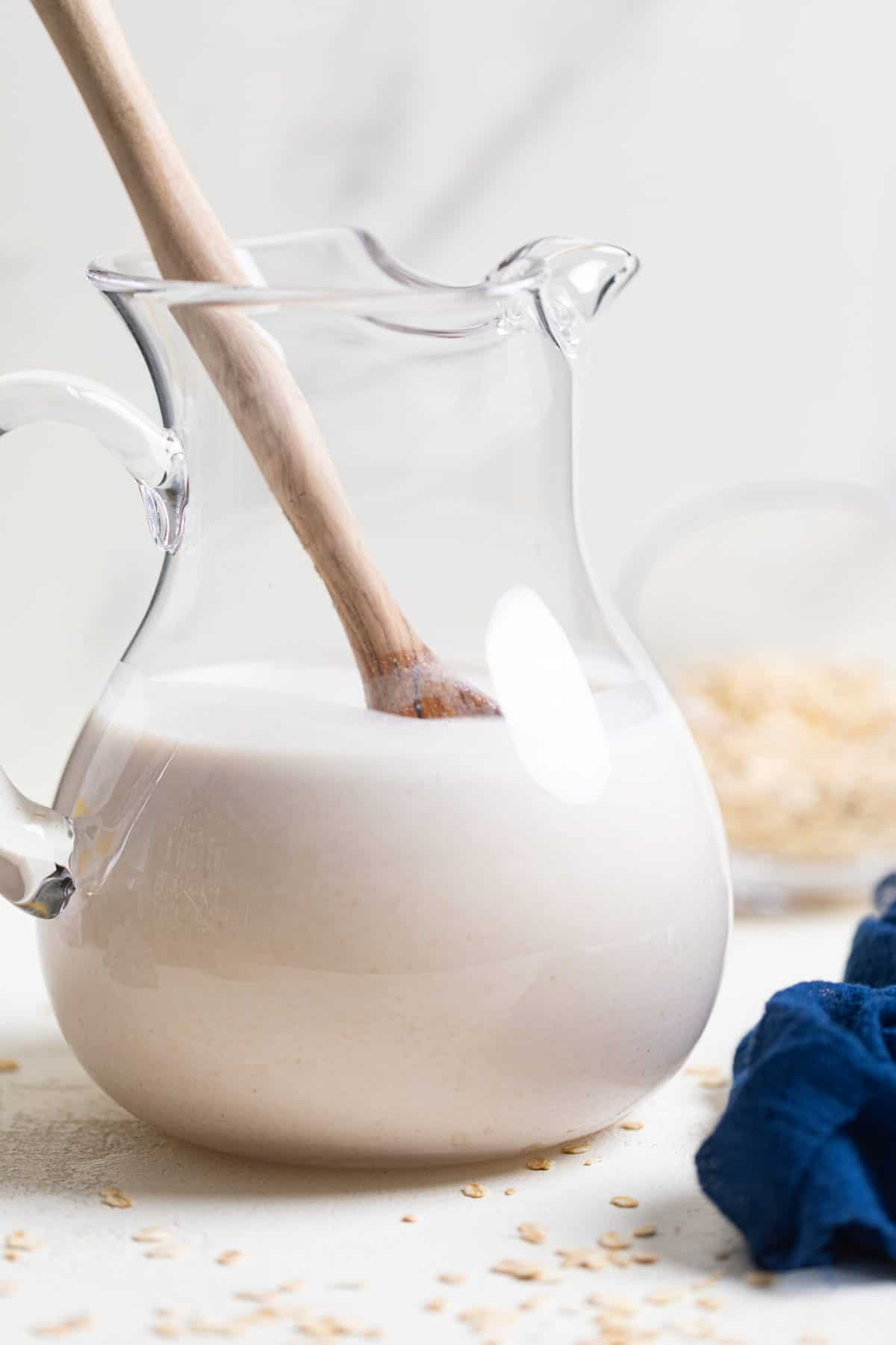 Spoon in a pitcher of Oat Milk.