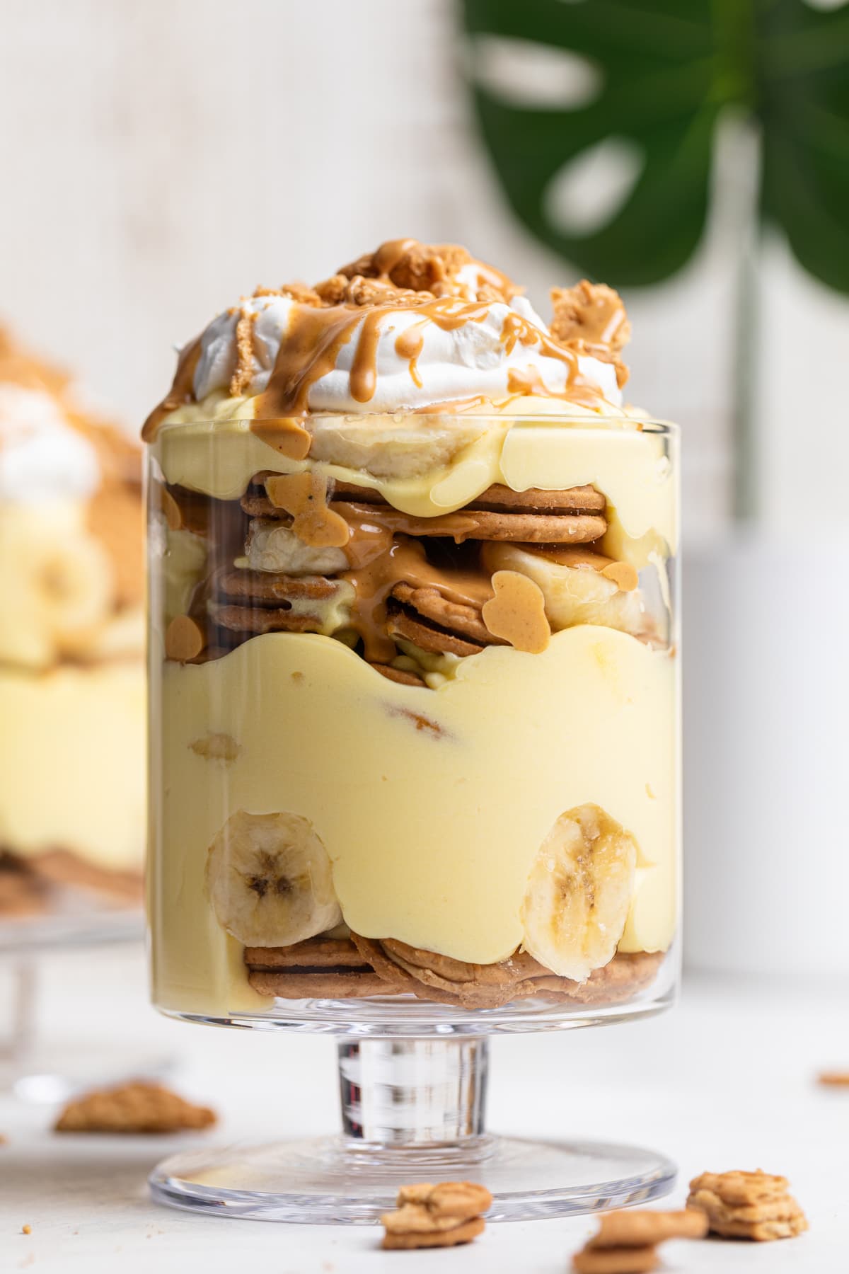 Overflowing glass of Peanut Butter Banana Pudding.