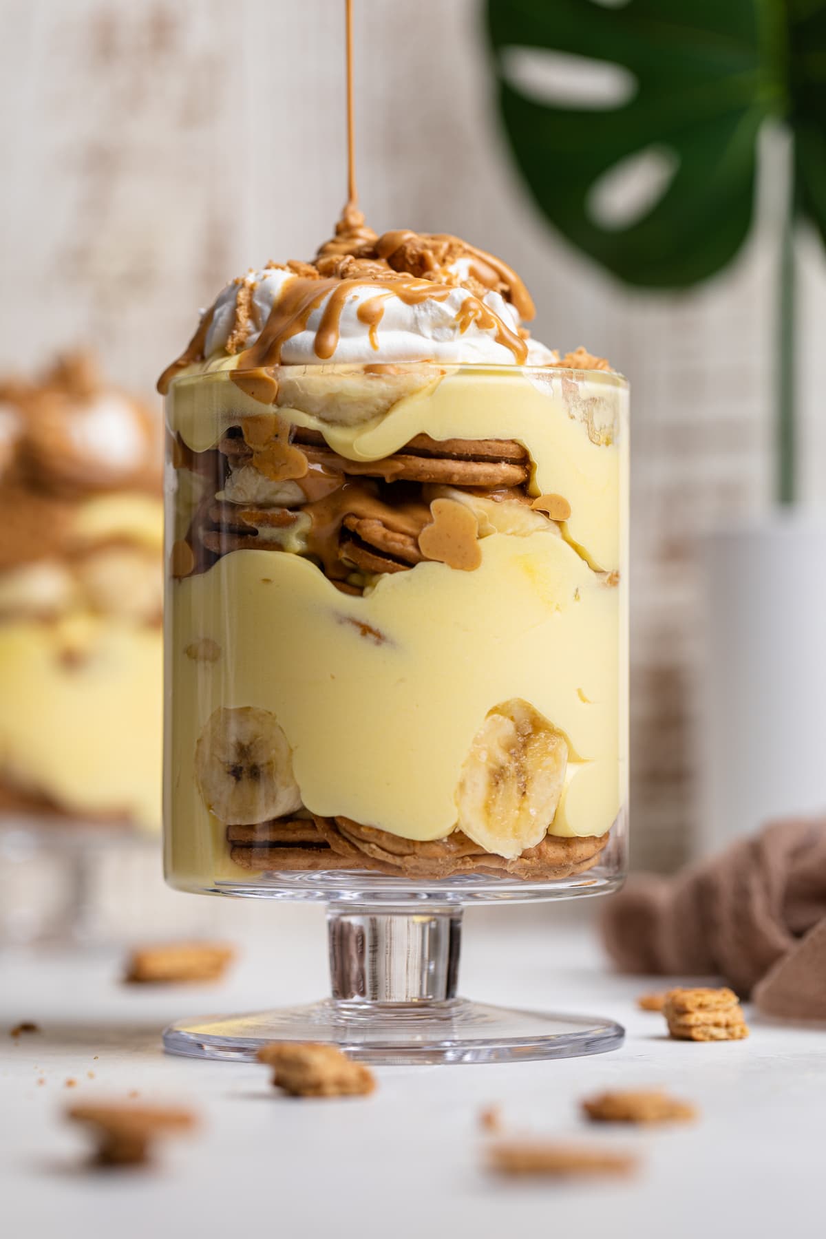 Natural peanut butter pouring onto Peanut Butter Banana Pudding.