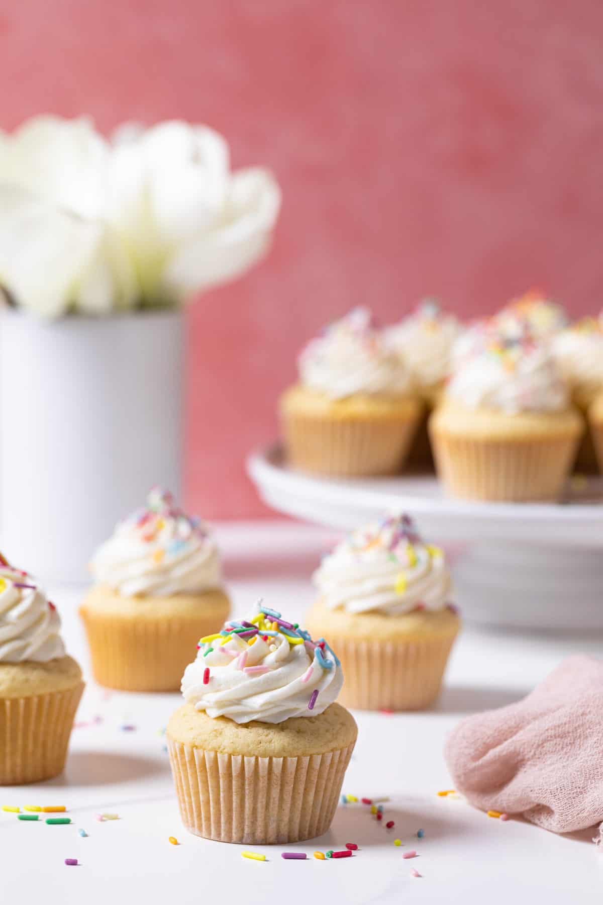 Vanilla Cupcakes with Buttercream Frosting on a white counter.