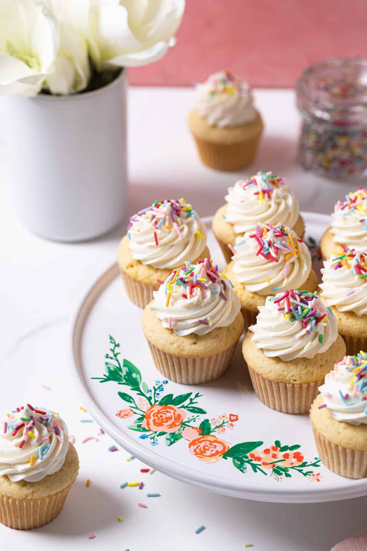 Vanilla Cupcakes with Buttercream Frosting topped with sprinkles.