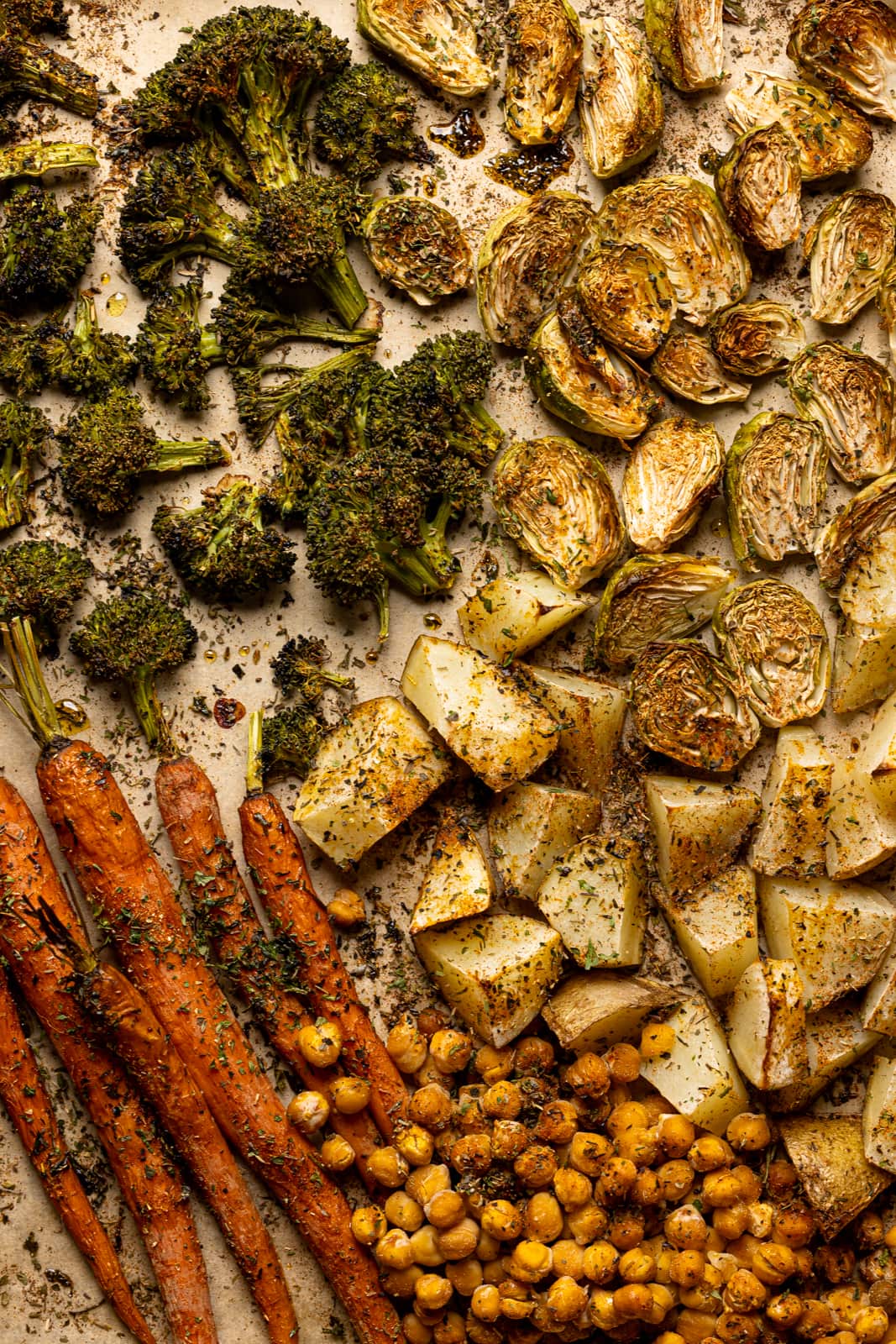 Roasted veggies on a baking sheet lined with parchment paper.