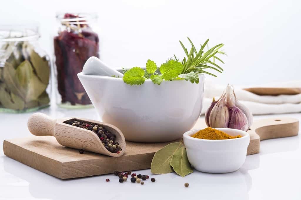 Herbs and spices on a wooden board.