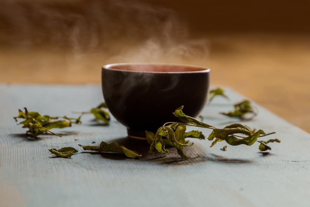 Dried leaves around a steaming bowl.