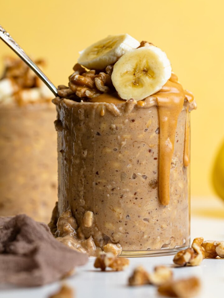 Overflowing glass of Banana Peanut Butter Overnight Oats