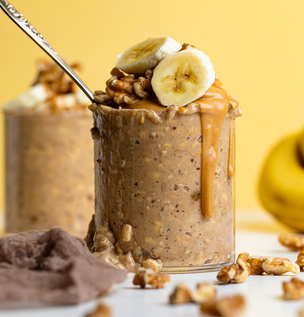 Overflowing glass of Banana Peanut Butter Overnight Oats