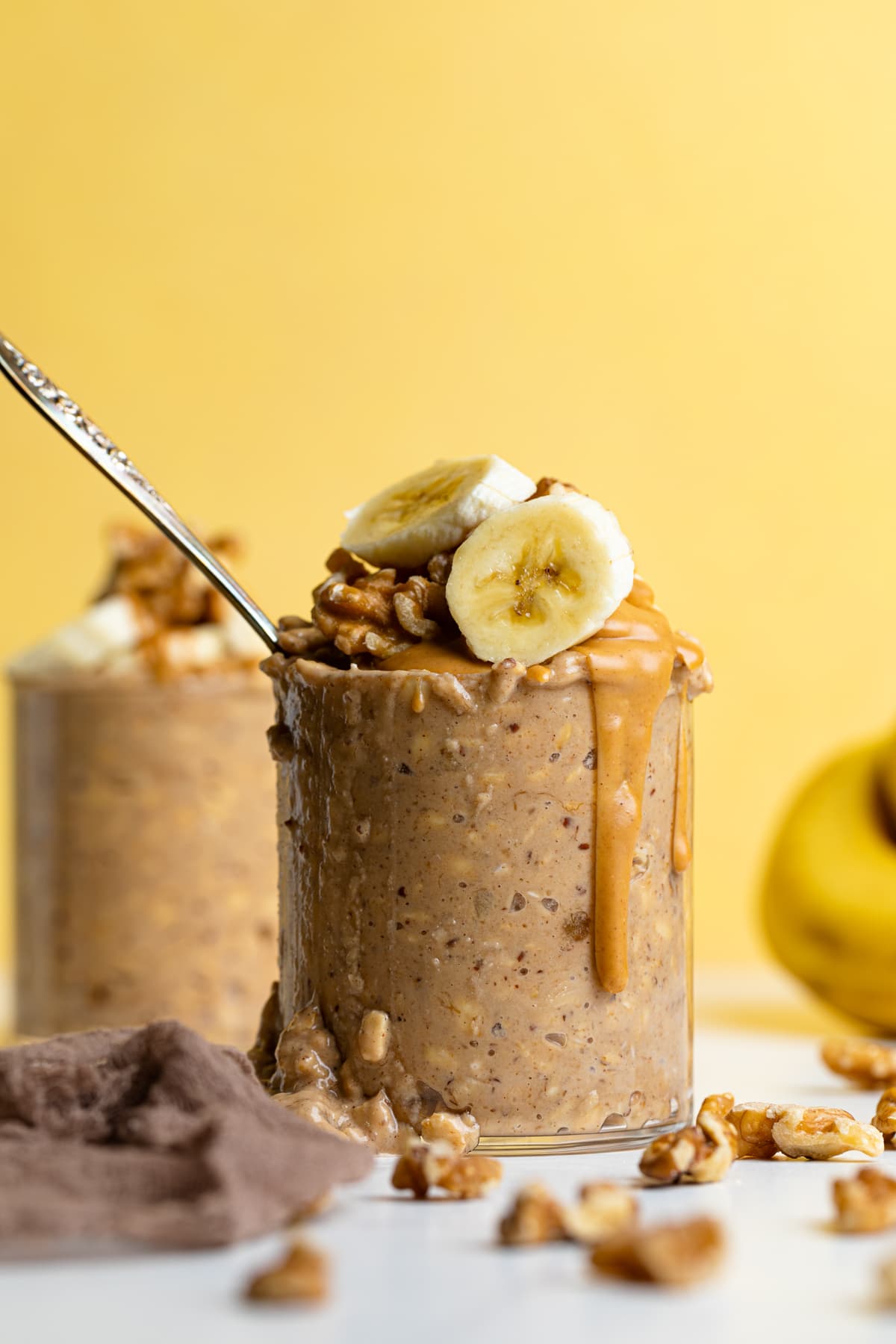 Overflowing glass of Banana Peanut Butter Overnight Oats