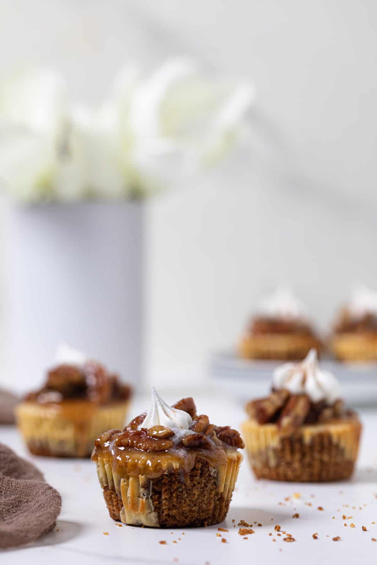 Pecan Pie Cheesecake Bites on a white surface.