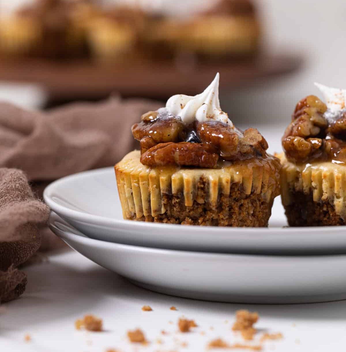 Pecan Pie Cheesecake Bites on two small, stacked plates