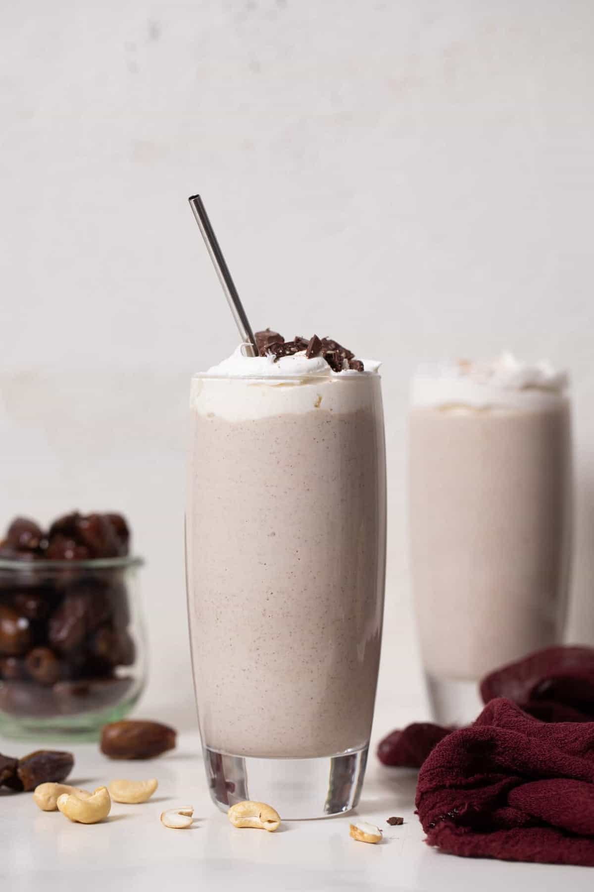 Two tall glasses of Cashew Date Morning Shake.