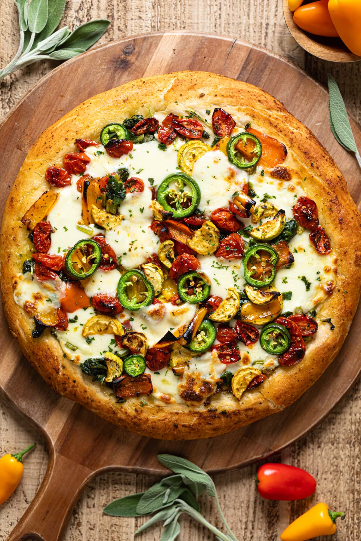 Overhead shot of a Veggie Pizza on a wooden board