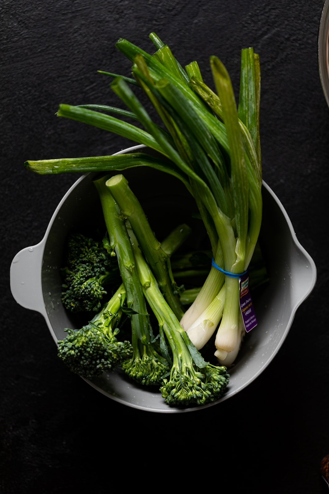 Green onion and broccoli in a bowl